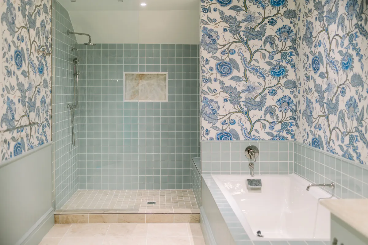 A spa-inspired bathroom showcasing a soaking tub, a walk-in shower, and elegant decorative wallpaper. The layout invites relaxation and self-care, evoking the atmosphere of a private wellness retreat.
